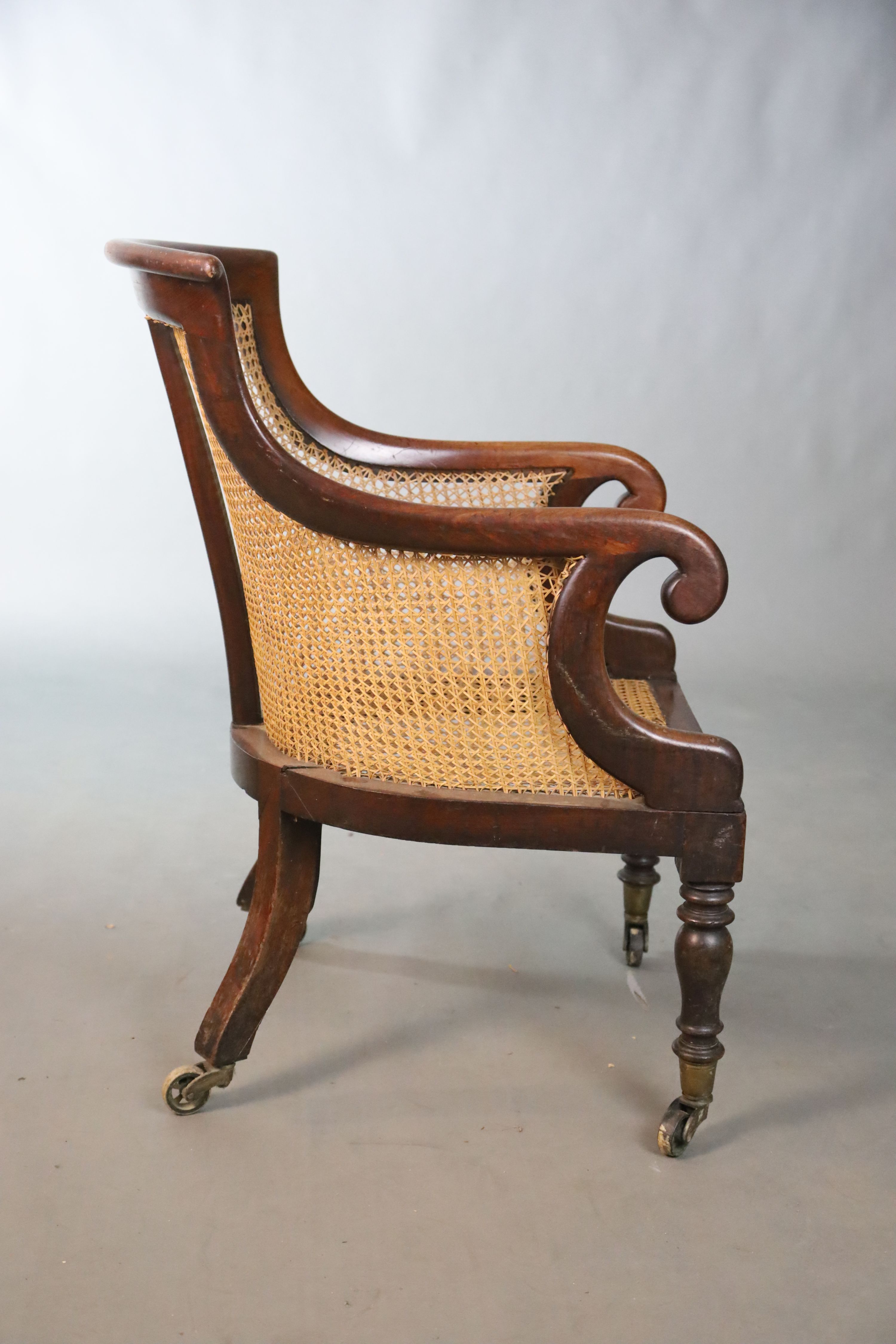A Regency mahogany bergere armchair, W.58.5cm D.66cm H.89cm